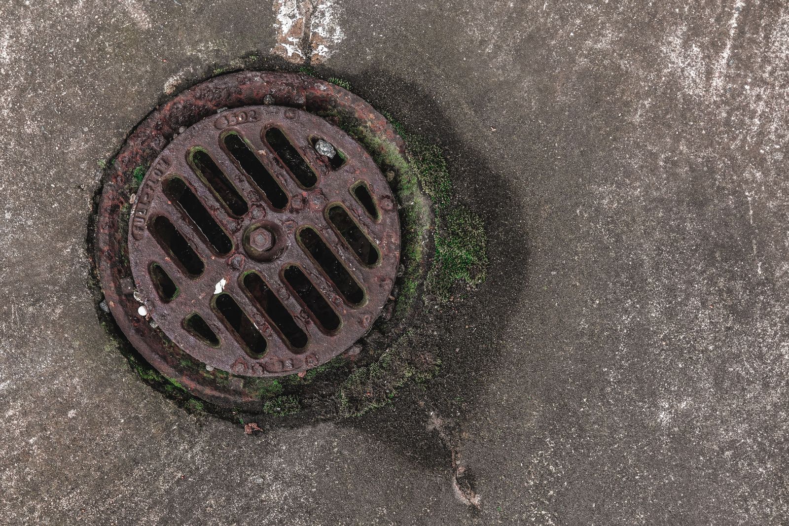 Water detection puck beside a floor drain